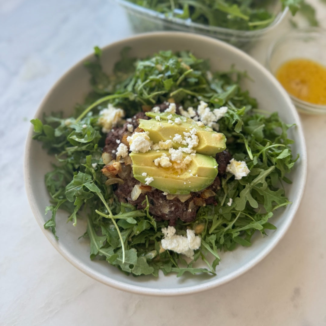 Venison Burger over Arugula Salad with Goat Cheese, Avocado, and Mustard Vinaigrette